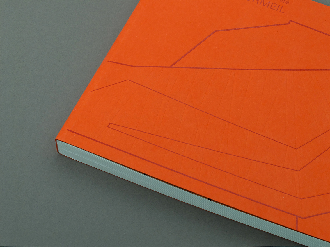 Livre à couverture rigide orange avec une illustration au trait minimal repose sur une surface grise, présentant un design graphique exquis.